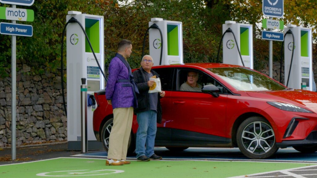 Troy Hawke Greeter's Guild at GRIDSERVE EV charging station in Moto Exeter MG4